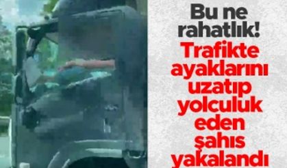 Trabzon'da trafikte ilginç görüntü - Ayaklarını uzatıp yolculuk eden şahıs yakalandı